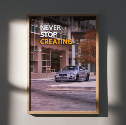 Motivational poster wall art featuring silver Nissan R34 GT-R Skyline with "Never Stop Creating" text in white and yellow.
