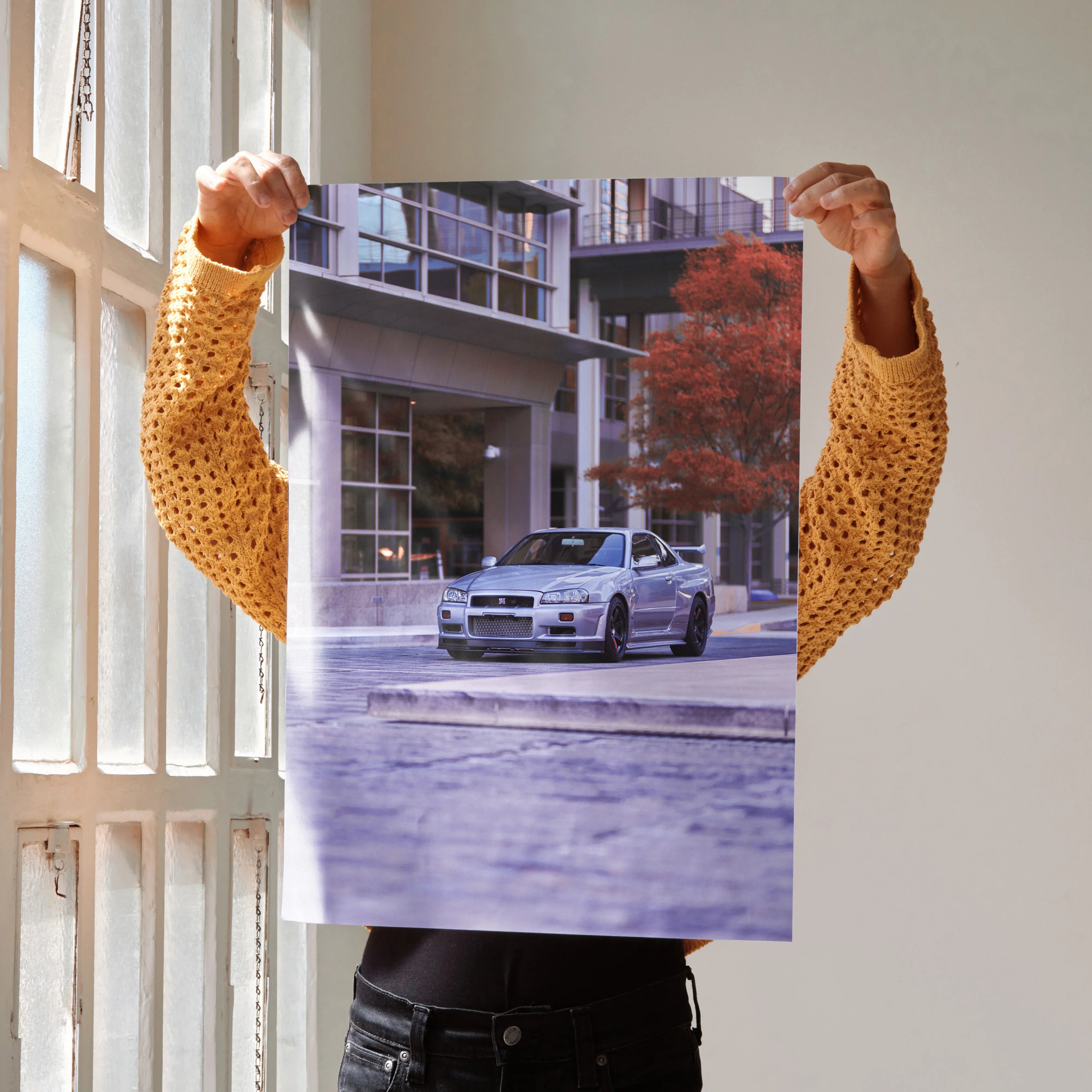 Nissan GTR R34 Skyline driving urban street poster with modern building background wall art.