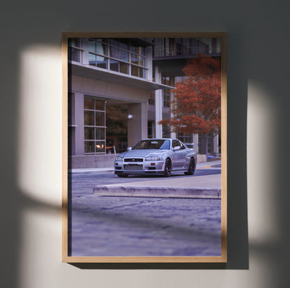 Nissan GTR R34 Skyline parked on city street vintage automotive poster wall art in wooden frame.