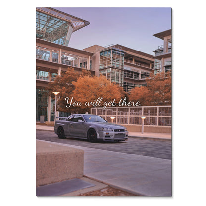 Nissan GT-R R34 Skyline parked by modern buildings with "You will get there" text poster wall art.