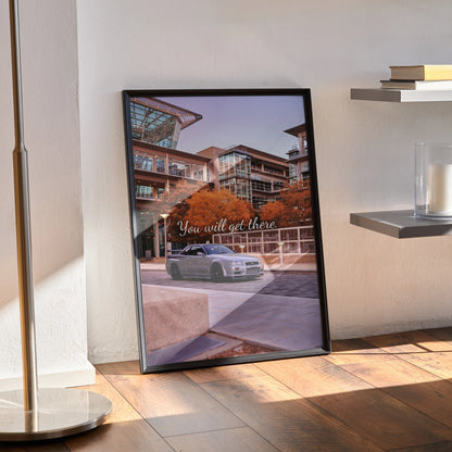 Framed Nissan GT-R R34 Skyline poster with modern building background and motivational text wall art.