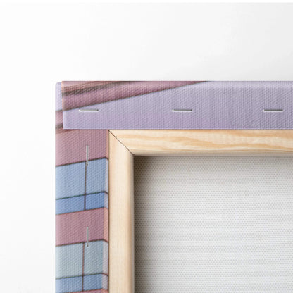 Close-up of gallery-wrapped canvas art with wooden frame and staple-secured edge for wall art display.