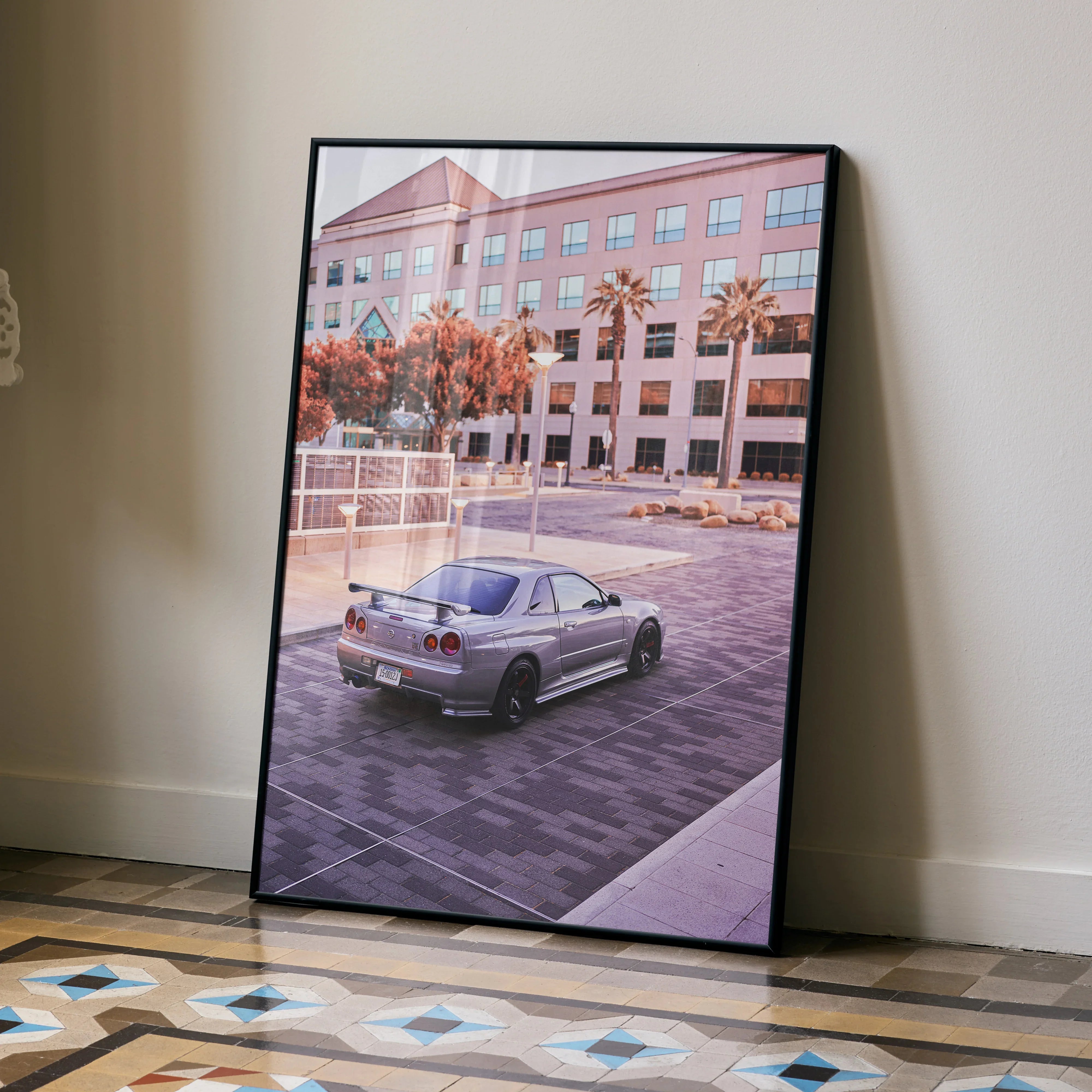 Nissan R34 GTR Skyline poster showcasing silver car in urban parking lot, modern wall art print.