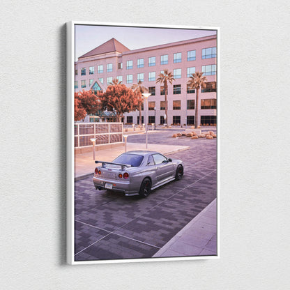 Nissan GTR R34 Skyline parked in front of office building canvas wall art in soft evening light.