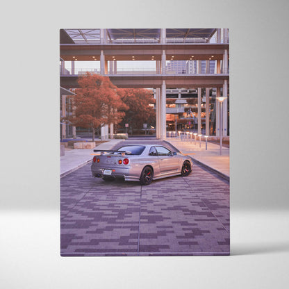 Nissan GTR R34 Skyline parked by modern building at sunset vertical canvas wall art print.