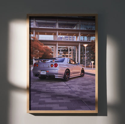 Nissan R34 GTR poster showing rear view of silver sports car with urban bridge background wall art.