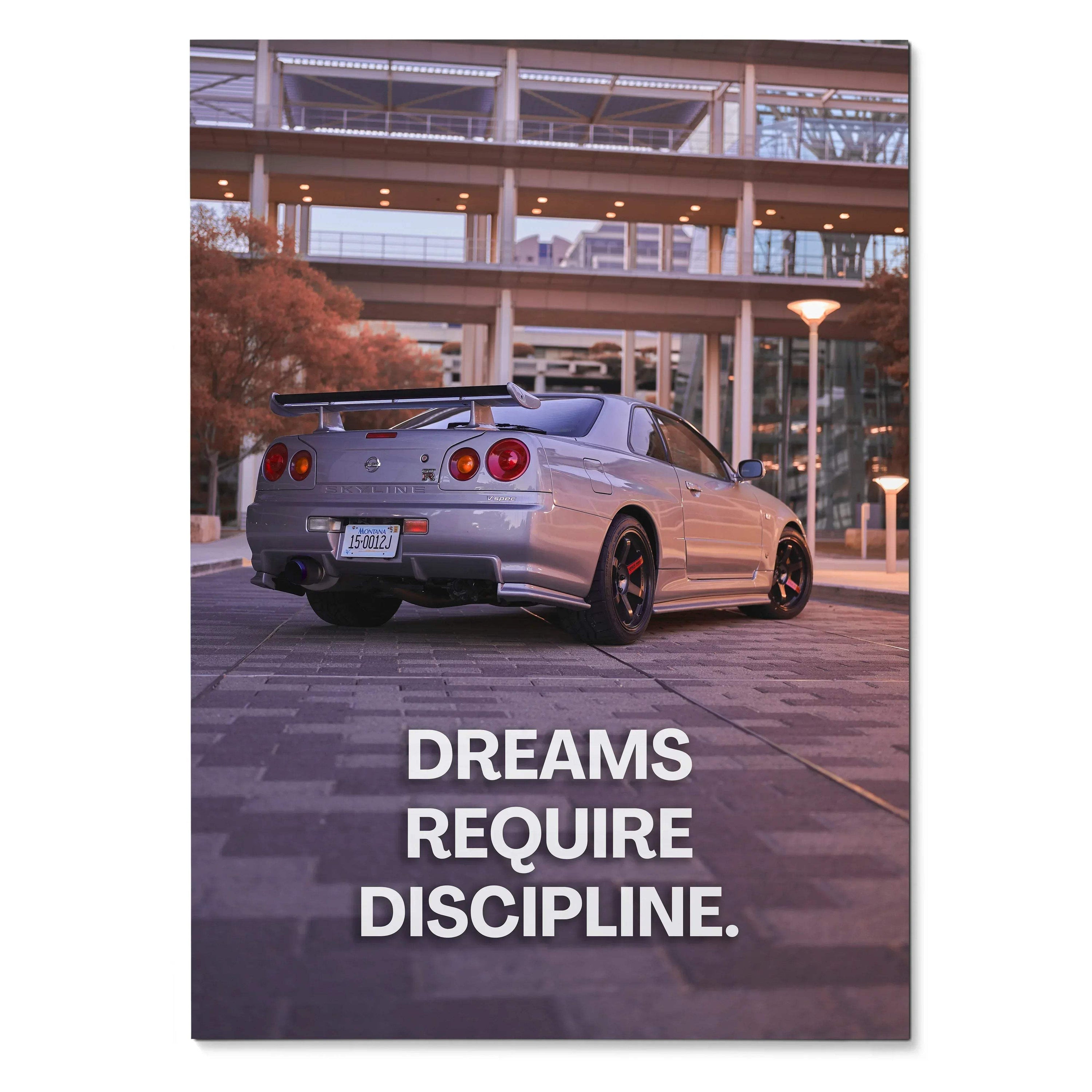 Nissan GT-R R34 Skyline parked at night with inspiring text "Dreams Require Discipline" poster wall art.
