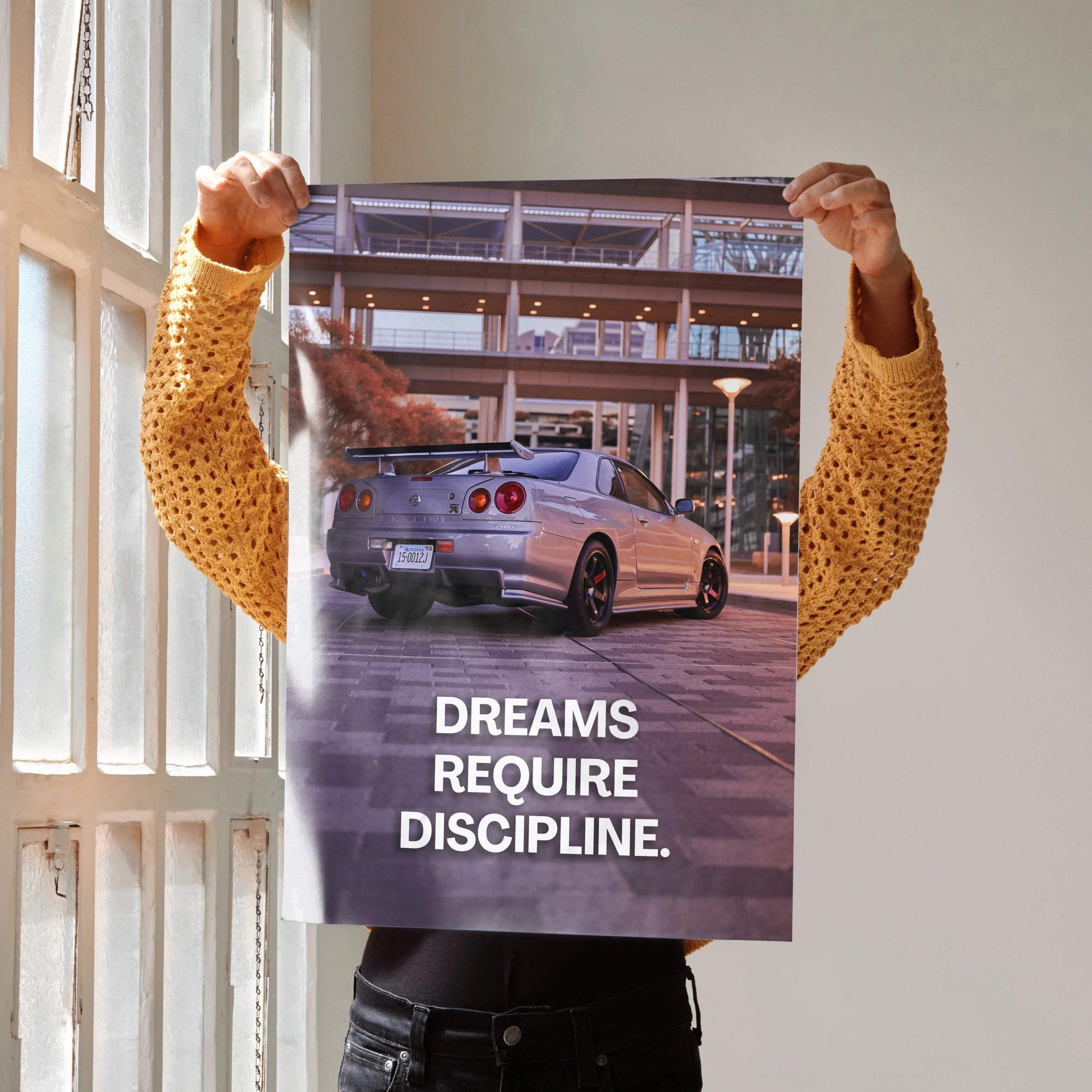Motivational poster featuring Nissan GT-R R34 Skyline with inspiring text "Dreams Require Discipline" wall art.