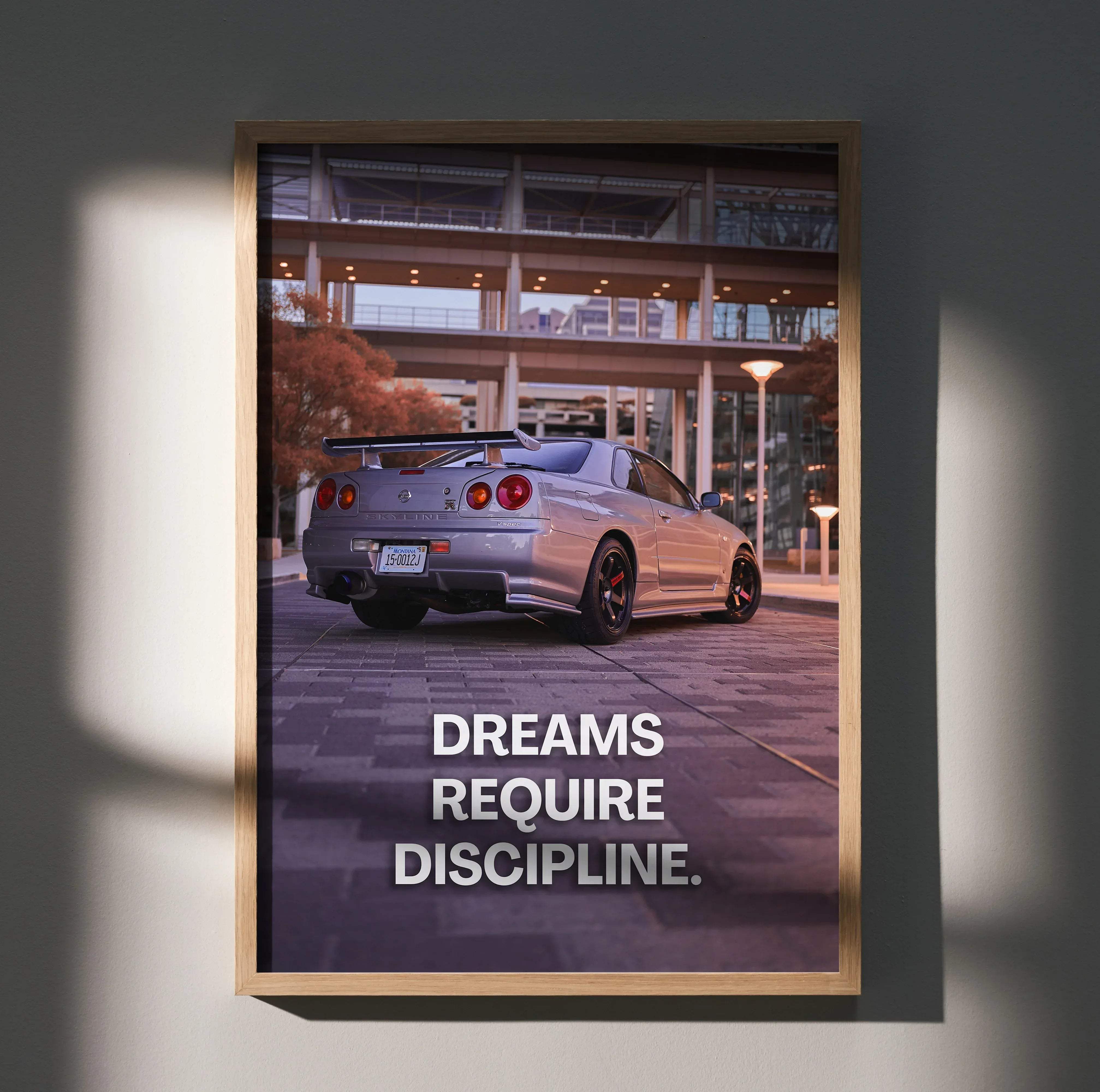 Silver Nissan GT-R sports car motivational poster in a light wood frame with inspiring text for wall decor