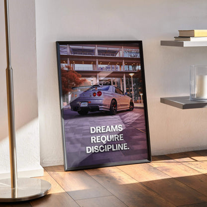 Nissan GT-R R34 Skyline poster wall art with "Dreams Require Discipline" text in black frame.