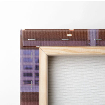 Close-up of wooden frame corner with detailed canvas texture and edge of printed automotive wall art.