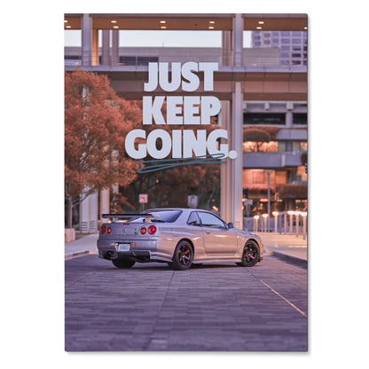 Motivational poster wall art with silver Nissan GT-R R34 Skyline and "Just Keep Going" text.