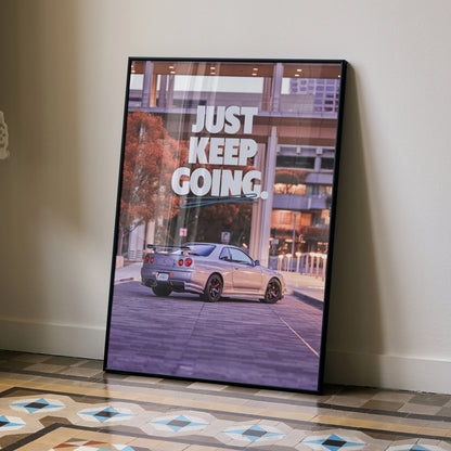 Motivational poster wall art featuring a silver Nissan R34 GT-R Skyline with "Just Keep Going" text.