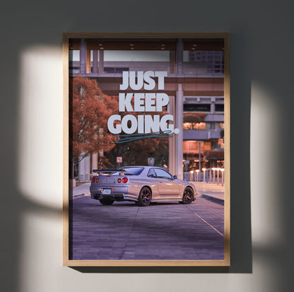 Motivational poster wall art featuring silver Nissan GT-R R34 Skyline with "Just Keep Going" text in urban setting.
