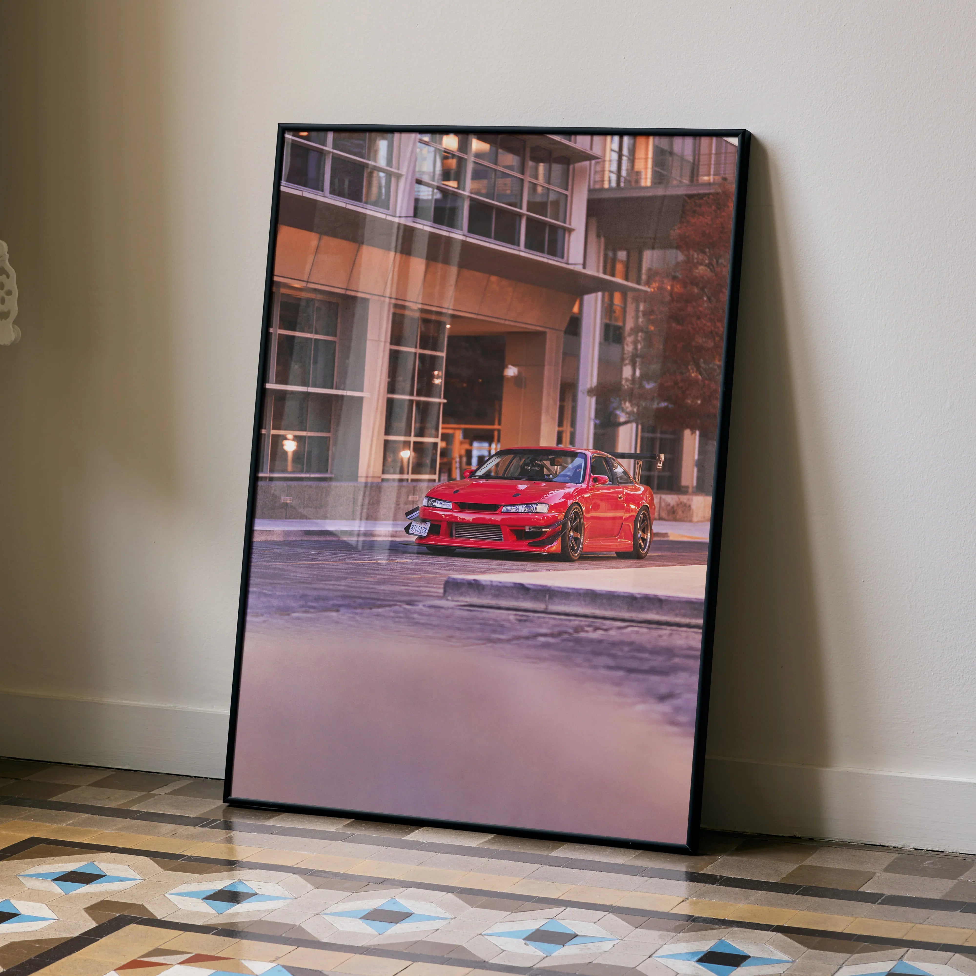Red Nissan 240sx S14 Kouki parked in urban setting poster wall art with modern building background.
