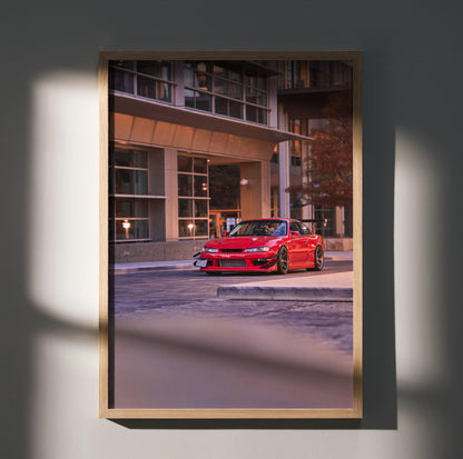 Red Nissan 240sx S14 Kouki parked in urban setting poster wall art with modern building backdrop.
