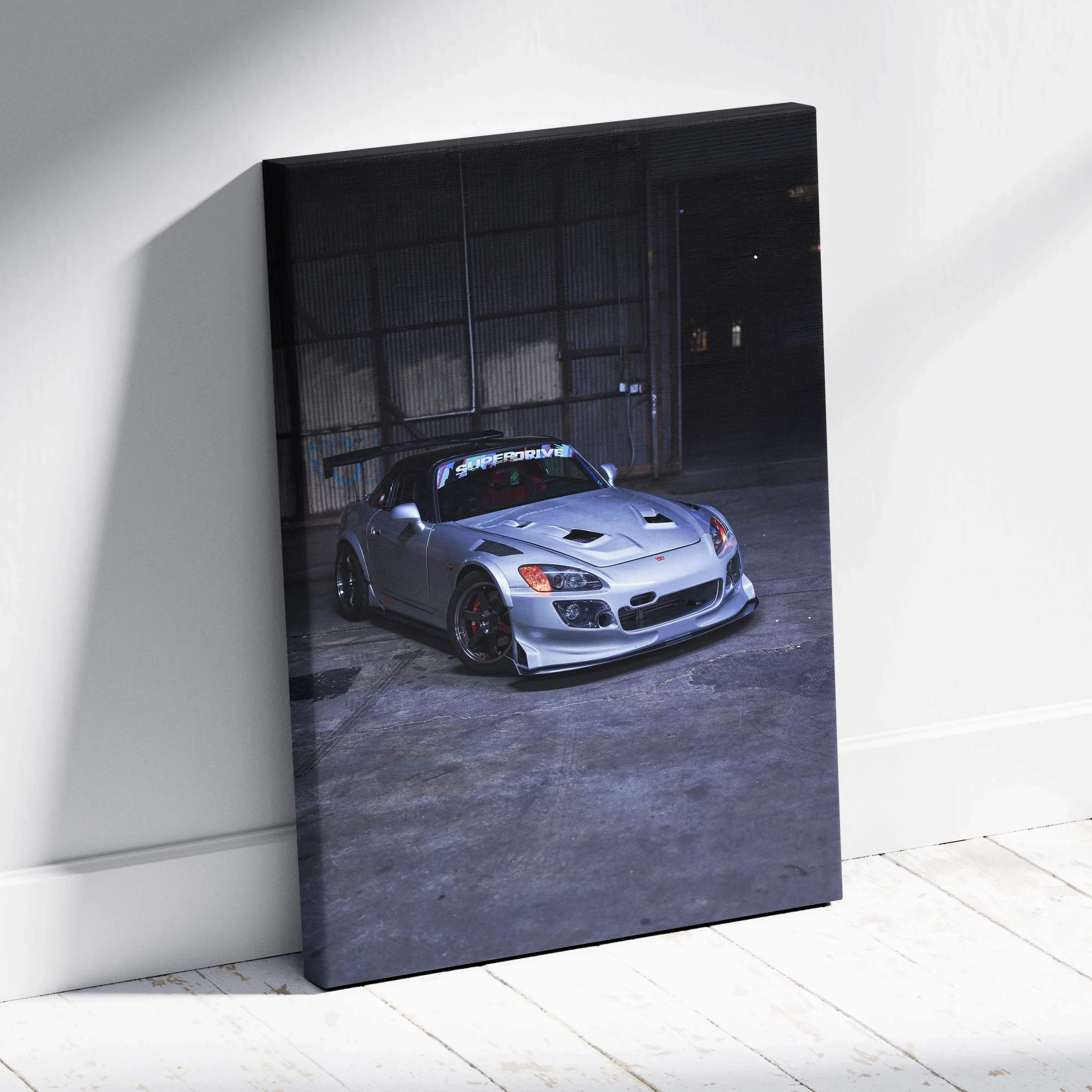 Silver honda s2000 sports car canvas wall art print with black racing stripes and red brake calipers at night