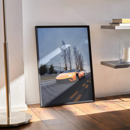 Lamborghini Huracan poster in black frame leaning on wooden floor, modern wall art with yellow sports car and trees.