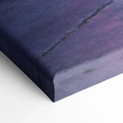 Close-up of museum-quality canvas print edge with visible textured fabric and vibrant blue and purple tones, vertical wall.