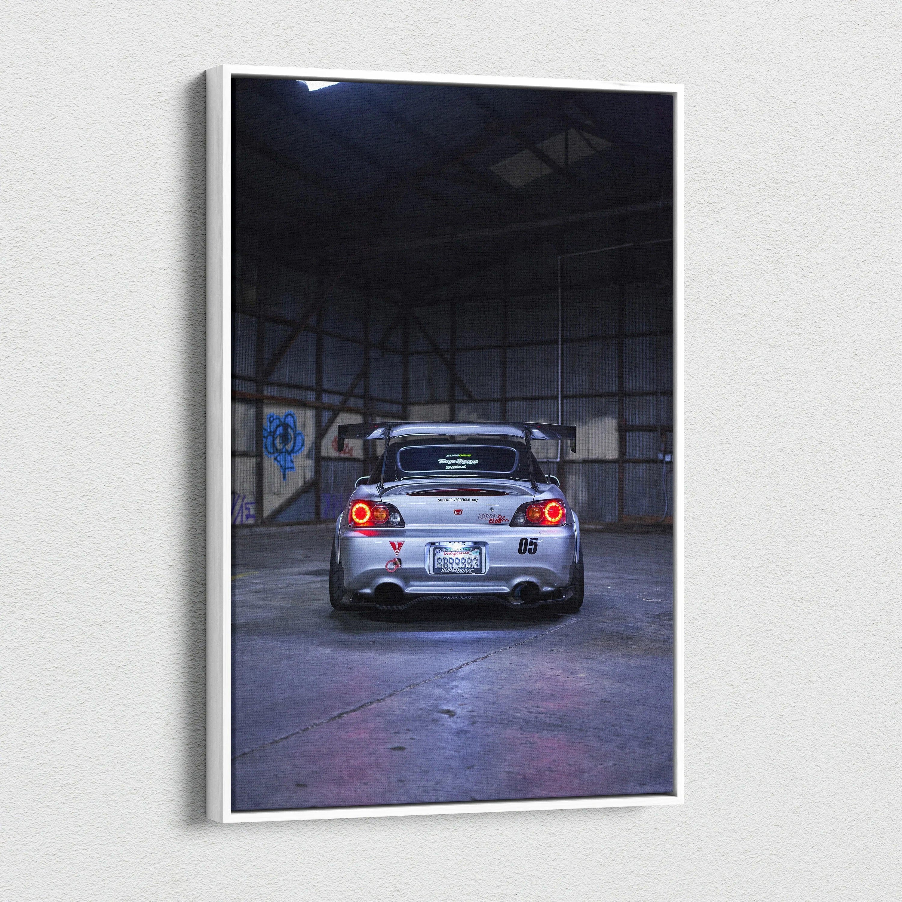 Vertical canvas wall art featuring a rear view of a silver Honda S2000 in a dimly lit industrial space.