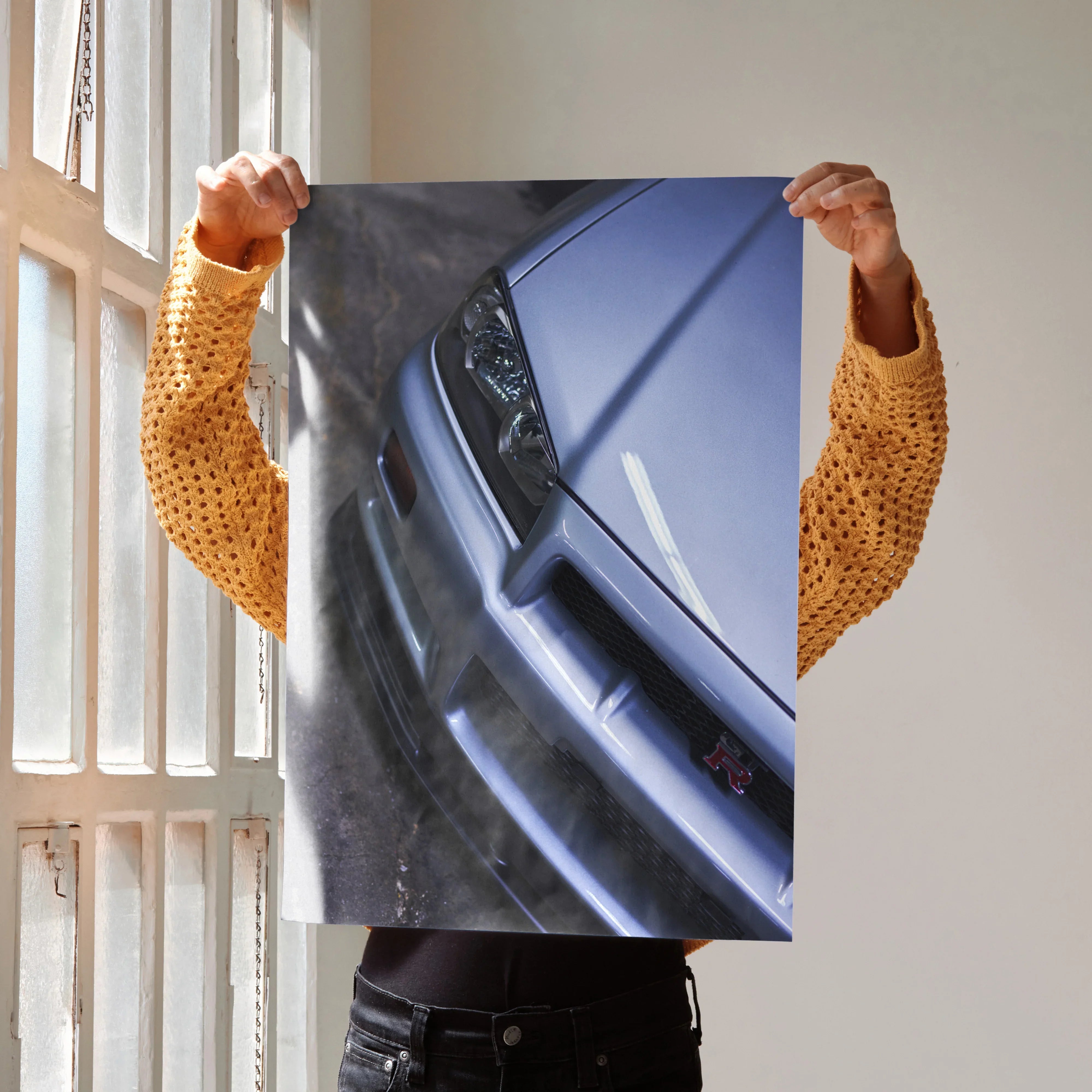 Nissan R34 GTR Skyline close-up poster showing front headlight and grille wall art.