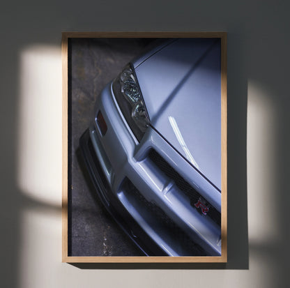 Nissan R34 GTR Skyline close-up poster showcasing front bumper and headlight in sleek silver wall art.