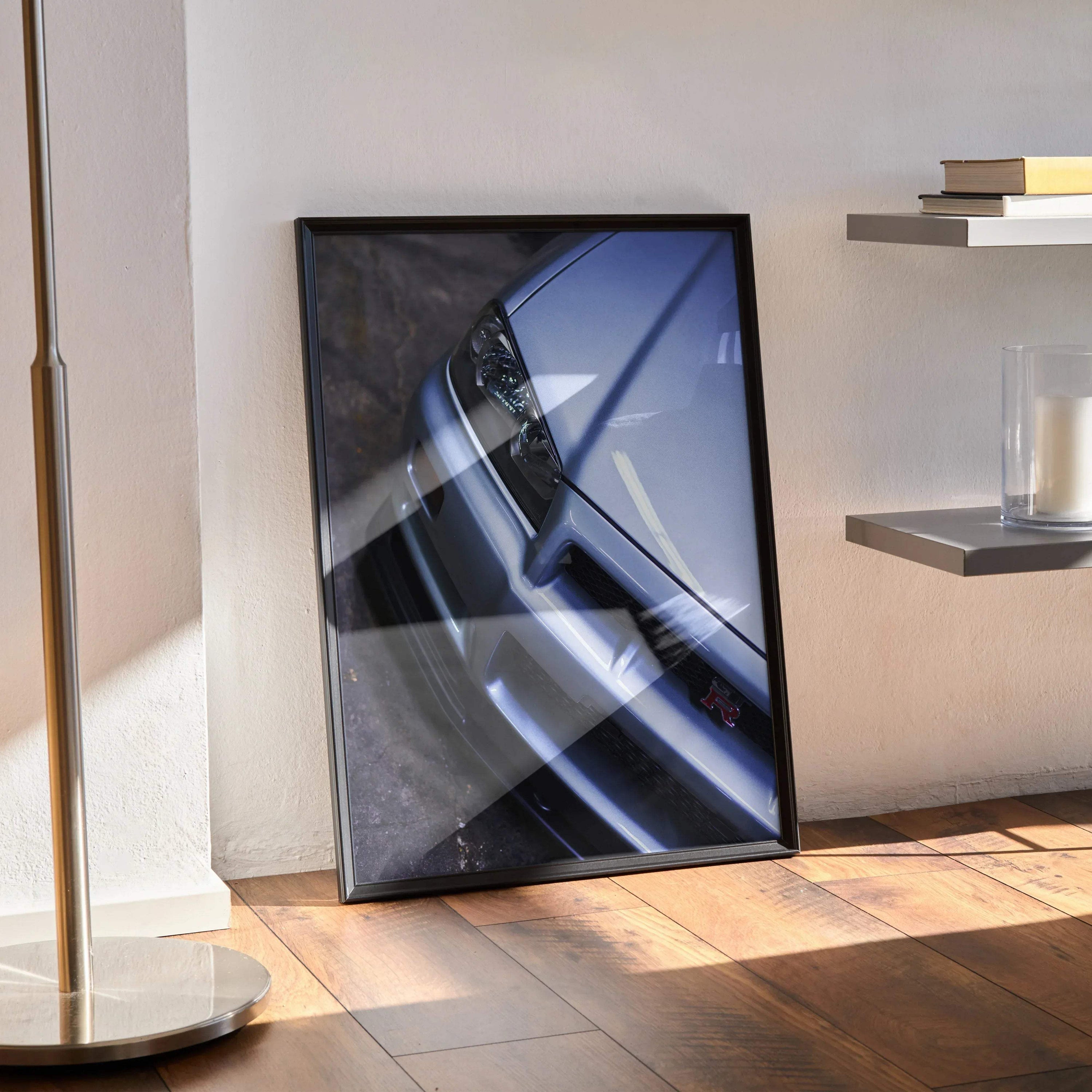 Nissan R34 GTR Skyline close-up poster with sleek silver car front in black frame wall art.