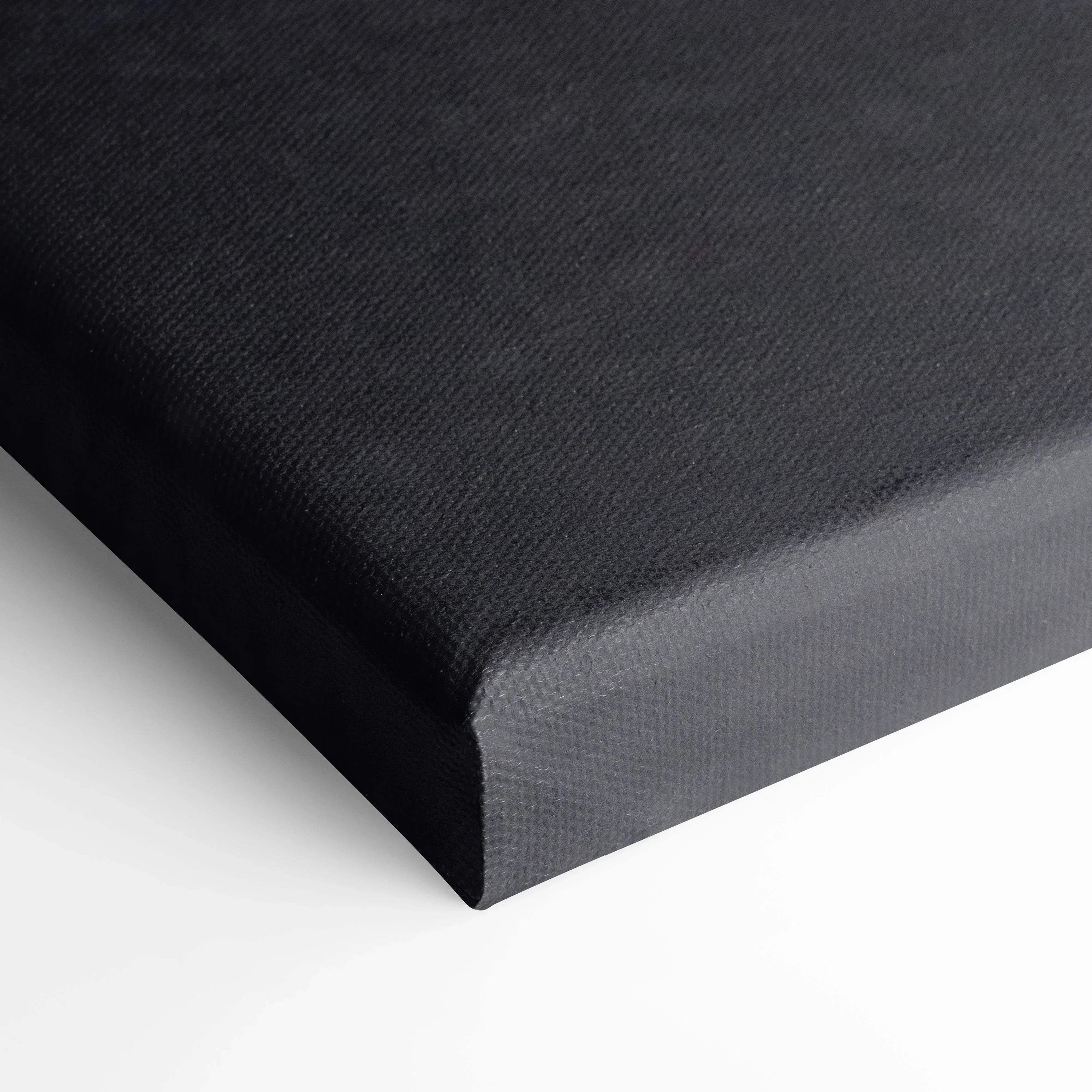 Black textured canvas wall art close-up corner showing wrapped edge and fine fabric weave.