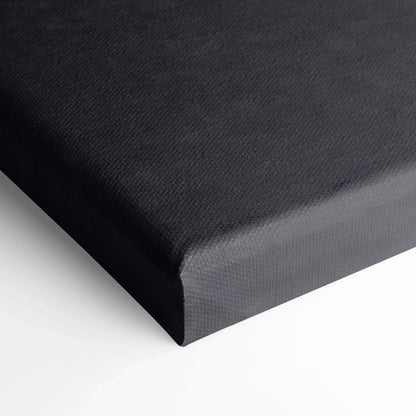 Black textured canvas wall art close-up corner showing wrapped edge and fine fabric weave.