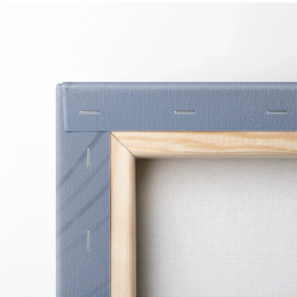 Close-up of stretched canvas corner with light wood frame and blue painted stretcher bars for wall art canvas print.