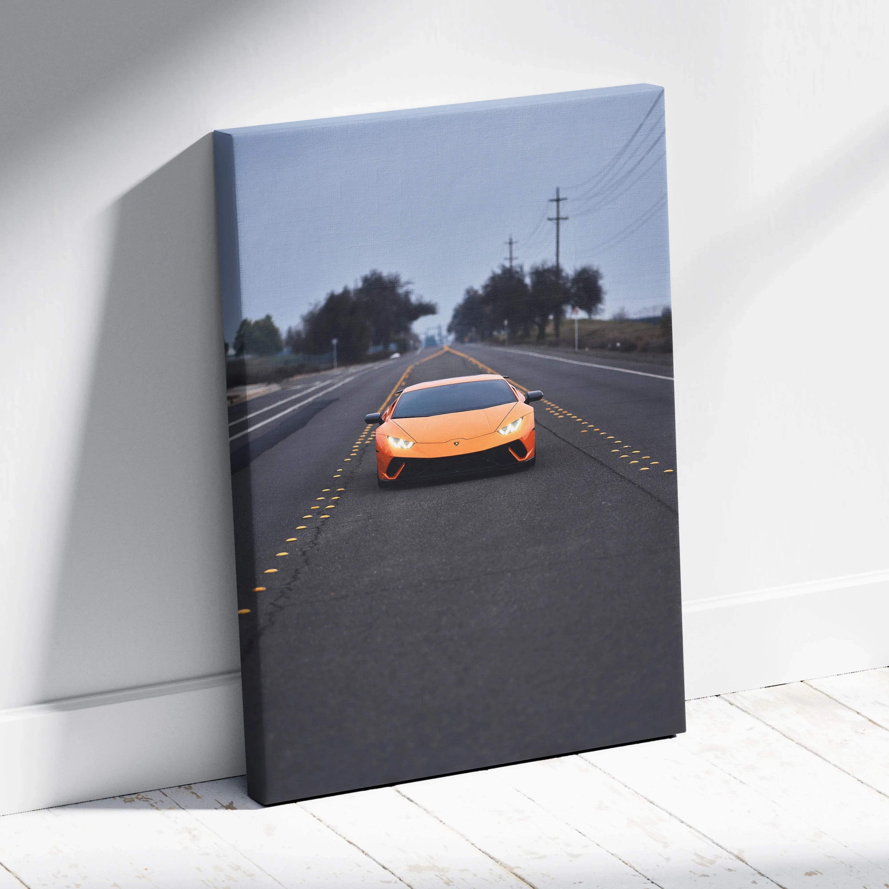 Vertical canvas wall art featuring a bright orange Lamborghini Huracan on a rural road at dusk.