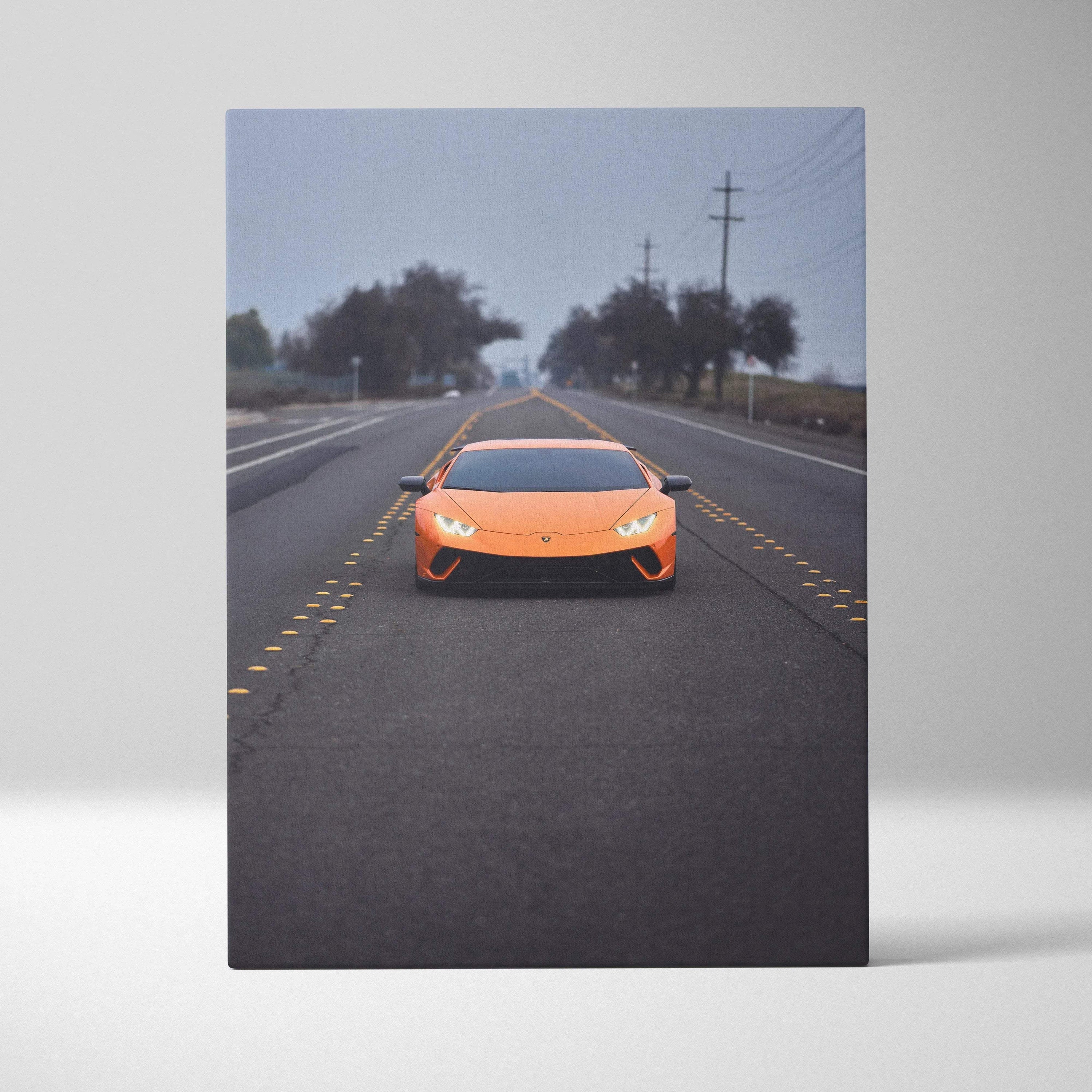 Orange Lamborghini Huracan on road with overcast sky, vertical canvas art wall decor.