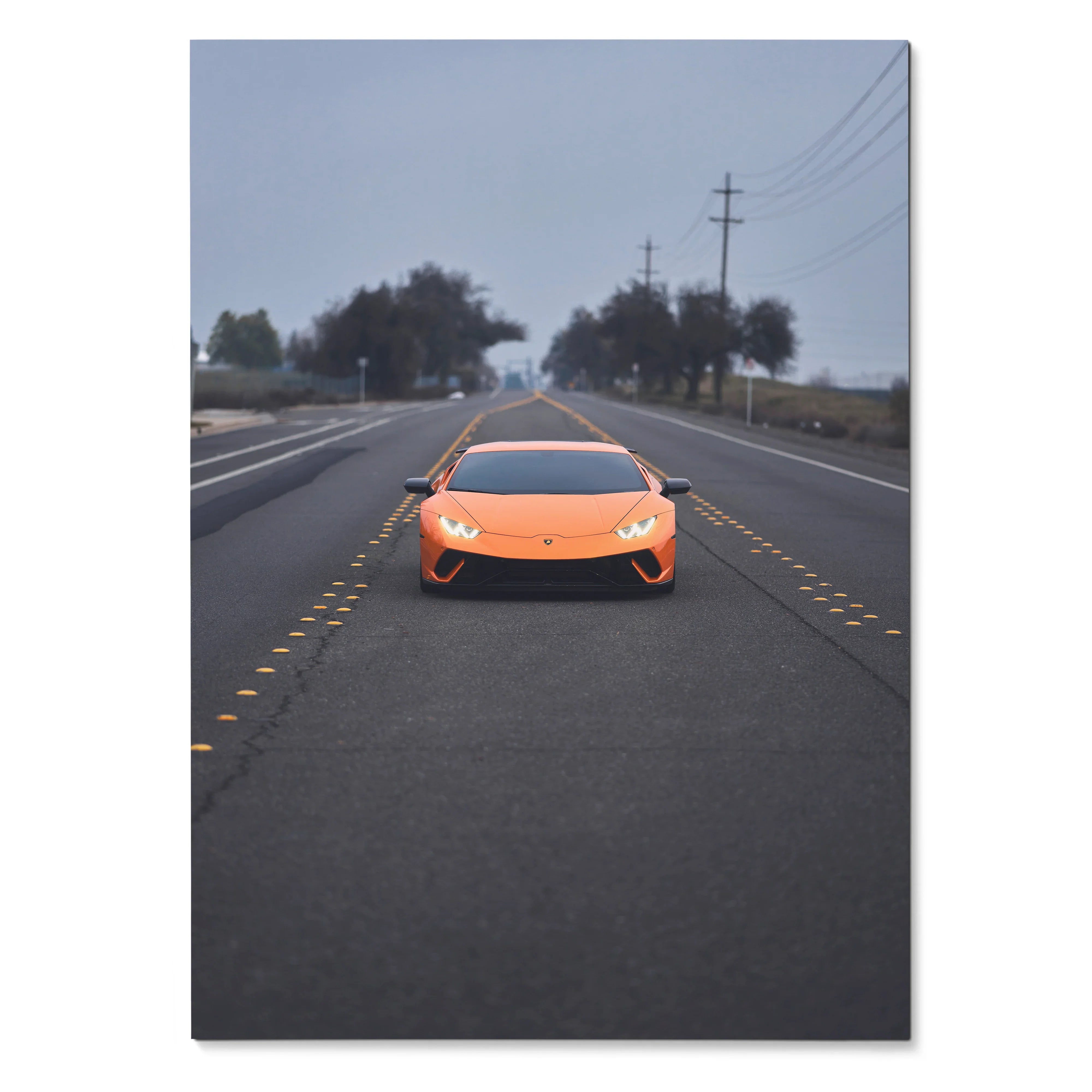 Orange Lamborghini Huracan with illuminated headlights on a foggy road poster wall art.