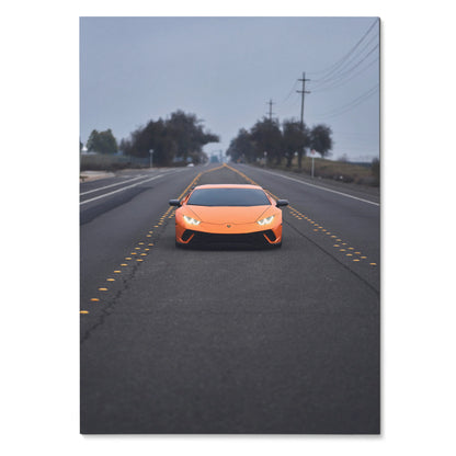 Orange Lamborghini Huracan with illuminated headlights on a foggy road poster wall art.