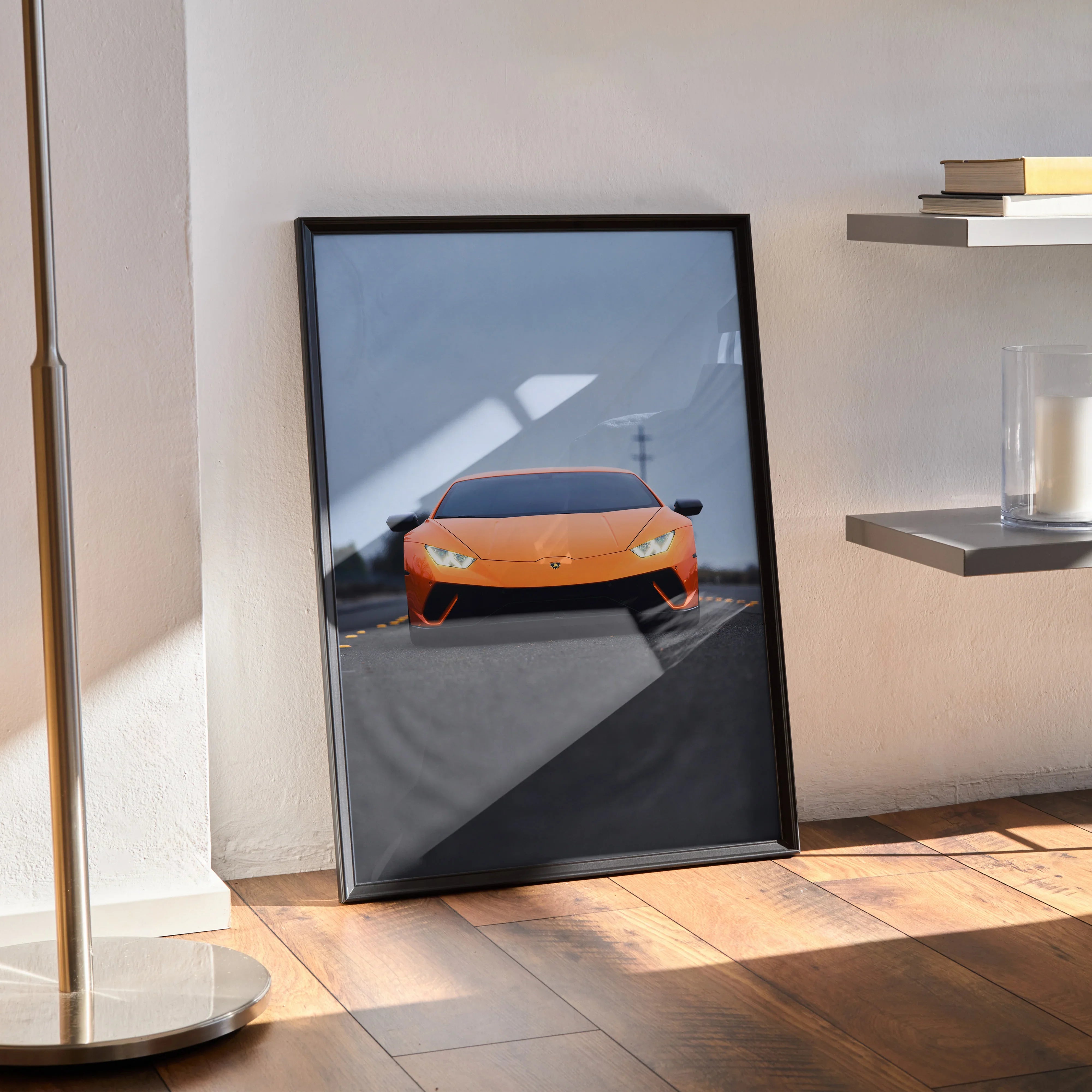 Lamborghini Huracan poster with orange supercar on road, framed wall art leaning indoors.