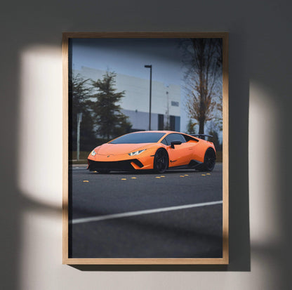 Orange Lamborghini Huracan poster in sleek wooden frame with urban background wall art.