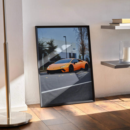 Lamborghini Huracan poster with vibrant orange sports car parked outdoors, sleek black frame wall art.