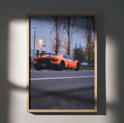 Orange Lamborghini Huracan parked on road at dusk luxury automotive poster wall art.