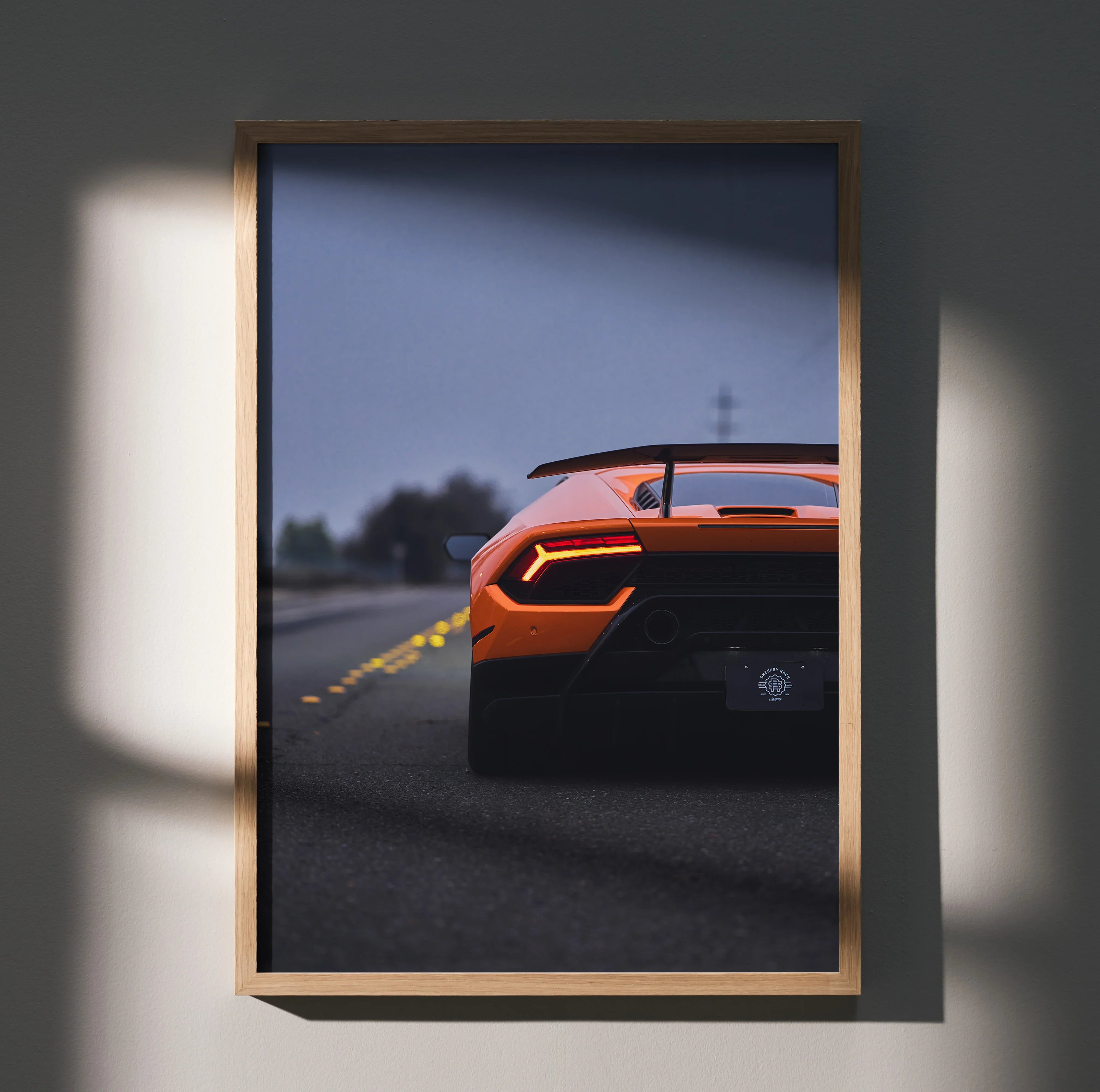 Lamborghini Huracan rear view poster wall art in wooden frame with dramatic lighting.