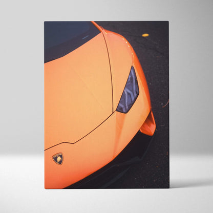 Orange Lamborghini Huracan close-up on black asphalt, vertical canvas wall art, modern car art.