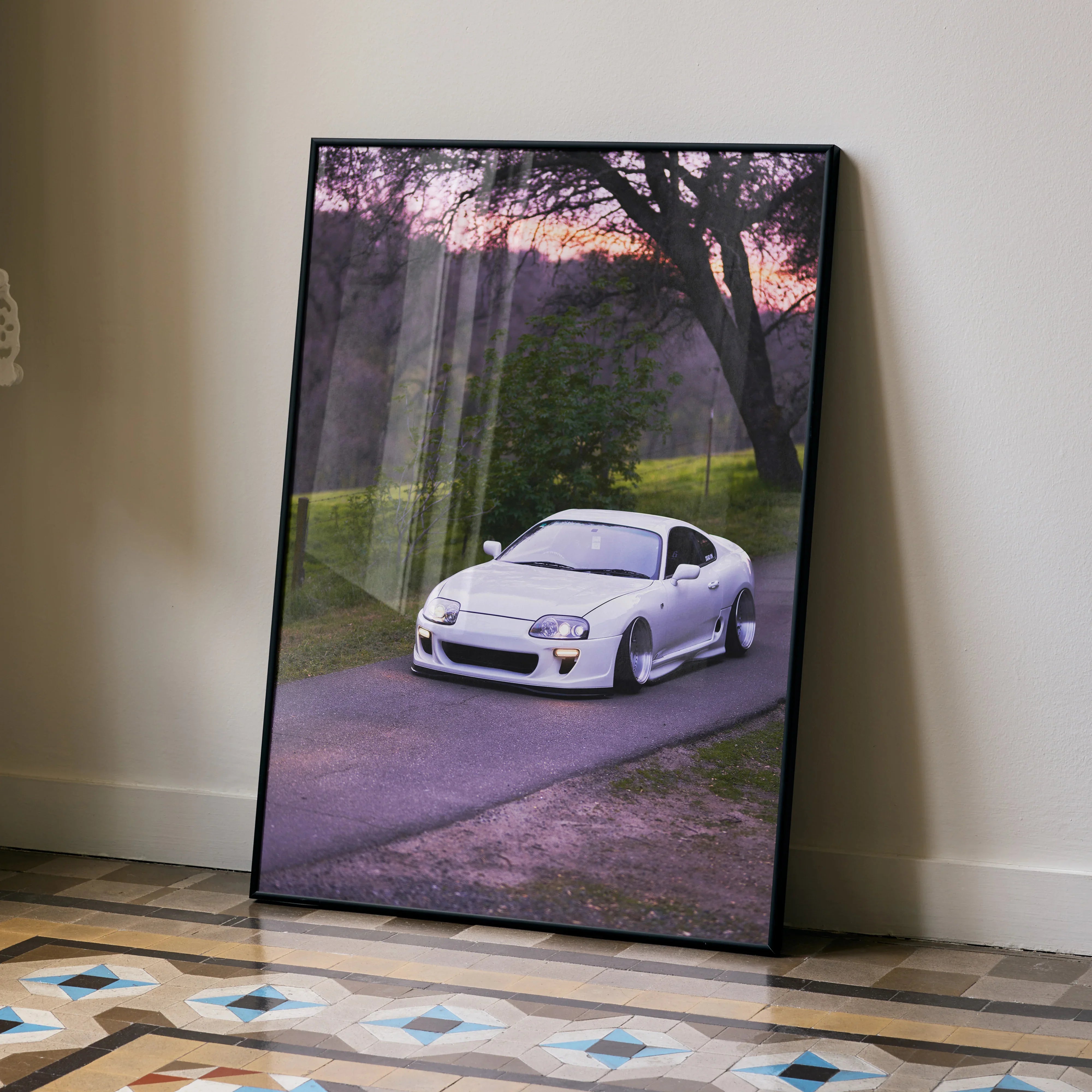 Toyota Supra MK4 parked on country road at sunset poster wall art in black frame.