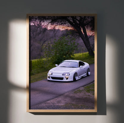 Toyota Supra MK4 on a scenic road during sunset, sleek white sports car poster wall art.
