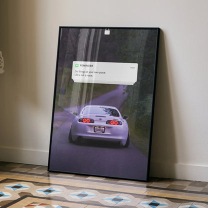 Motivational poster wall art featuring Toyota Supra Mk4 rear view on a forest road with inspiring text overlay.