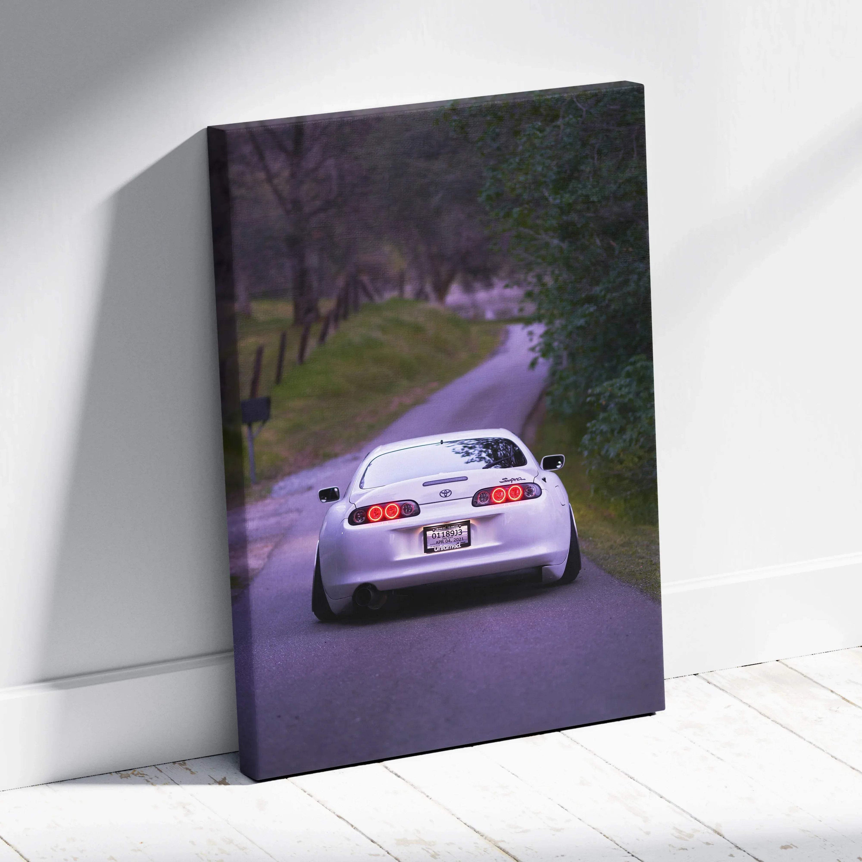 Toyota Supra MK4 driving on a tree-lined road canvas wall art with high-resolution car photo.