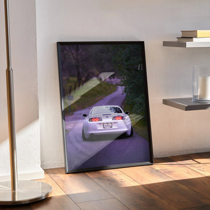 Toyota Supra MK4 rear view poster leaning against wall, automotive wall art in dark frame.