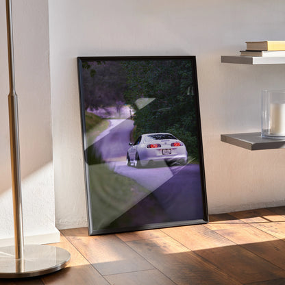 Toyota Supra MK4 racing down a winding road poster framed as wall art with natural lighting.