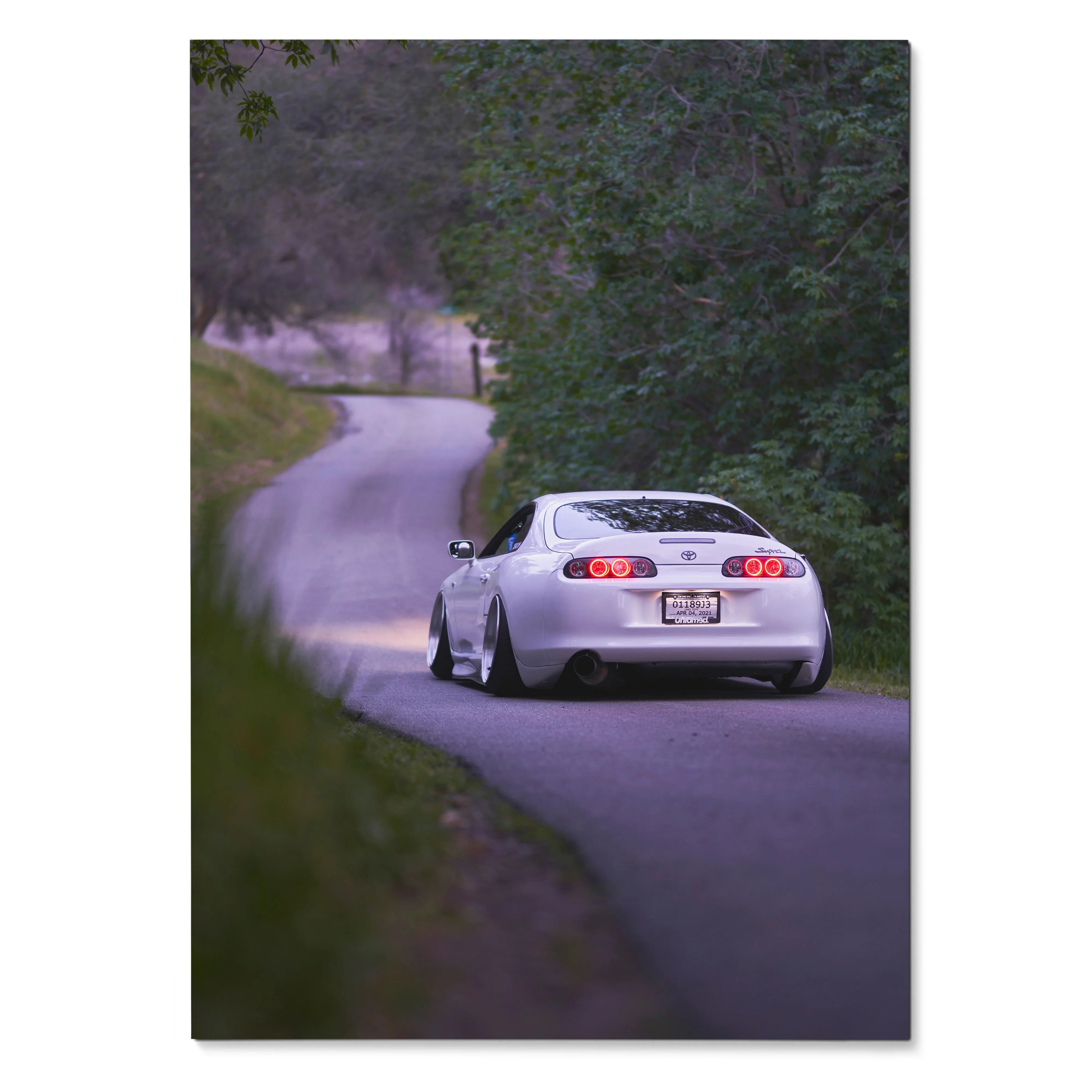 Toyota Supra MK4 driving on winding forest road poster, high-resolution wall art.