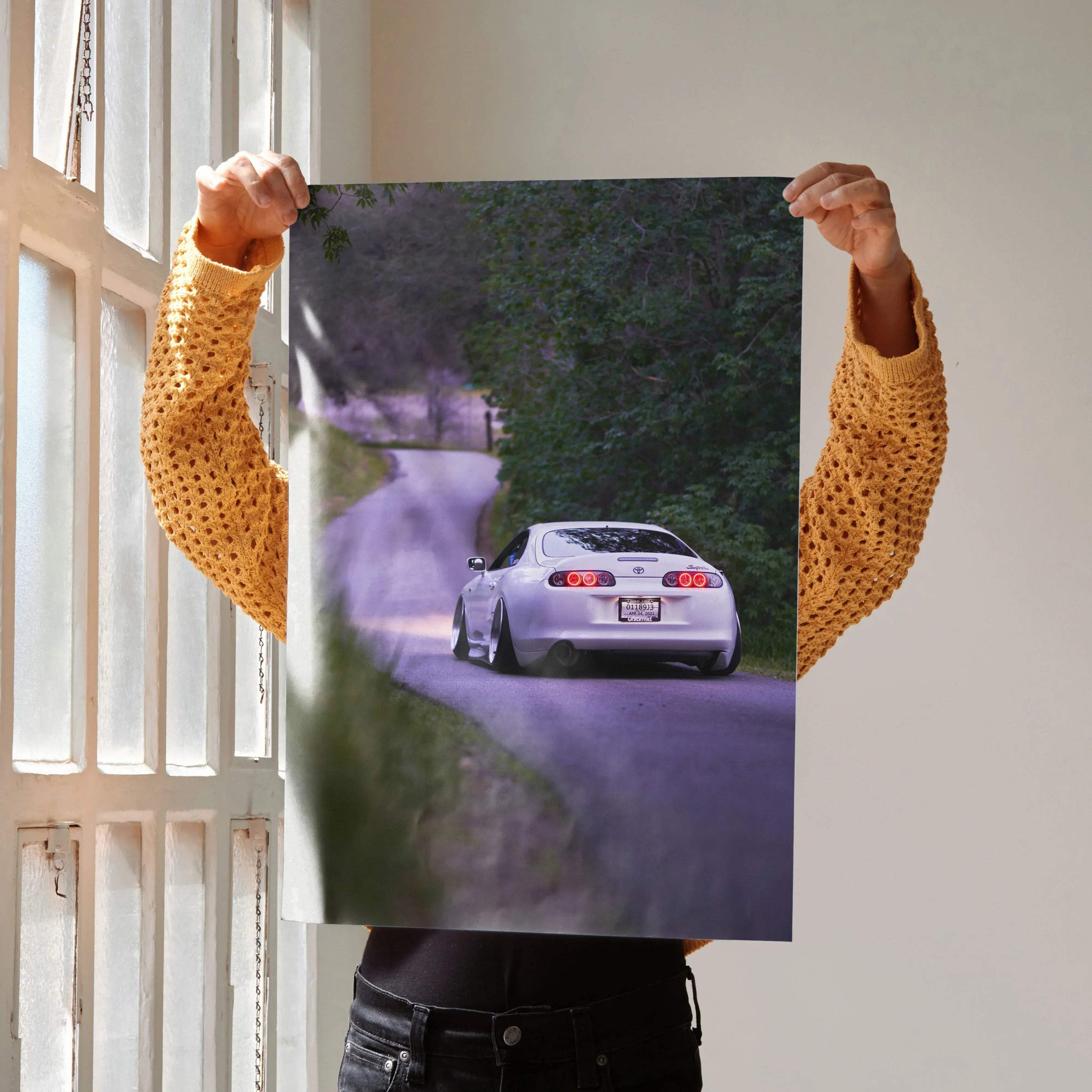 Toyota Supra MK4 poster wall art featuring a rear view on a winding road in high resolution.