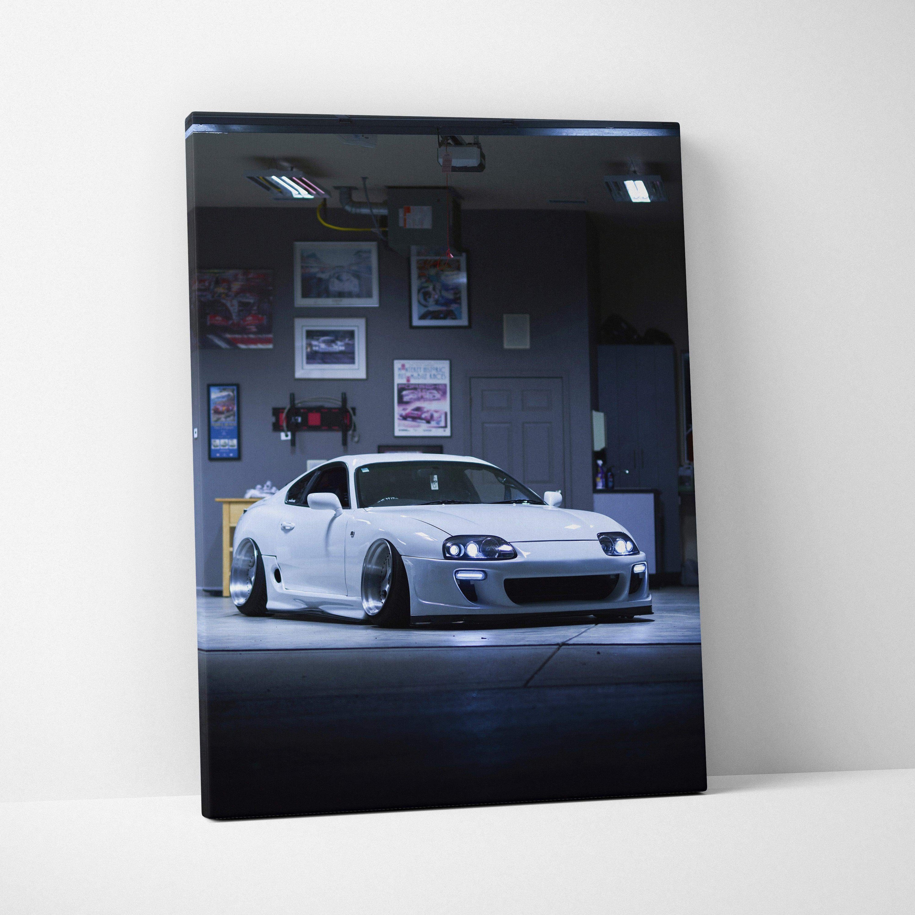 Vertical canvas art of white Toyota Supra MK4 sports car in a dimly lit garage, sleek wall art print.