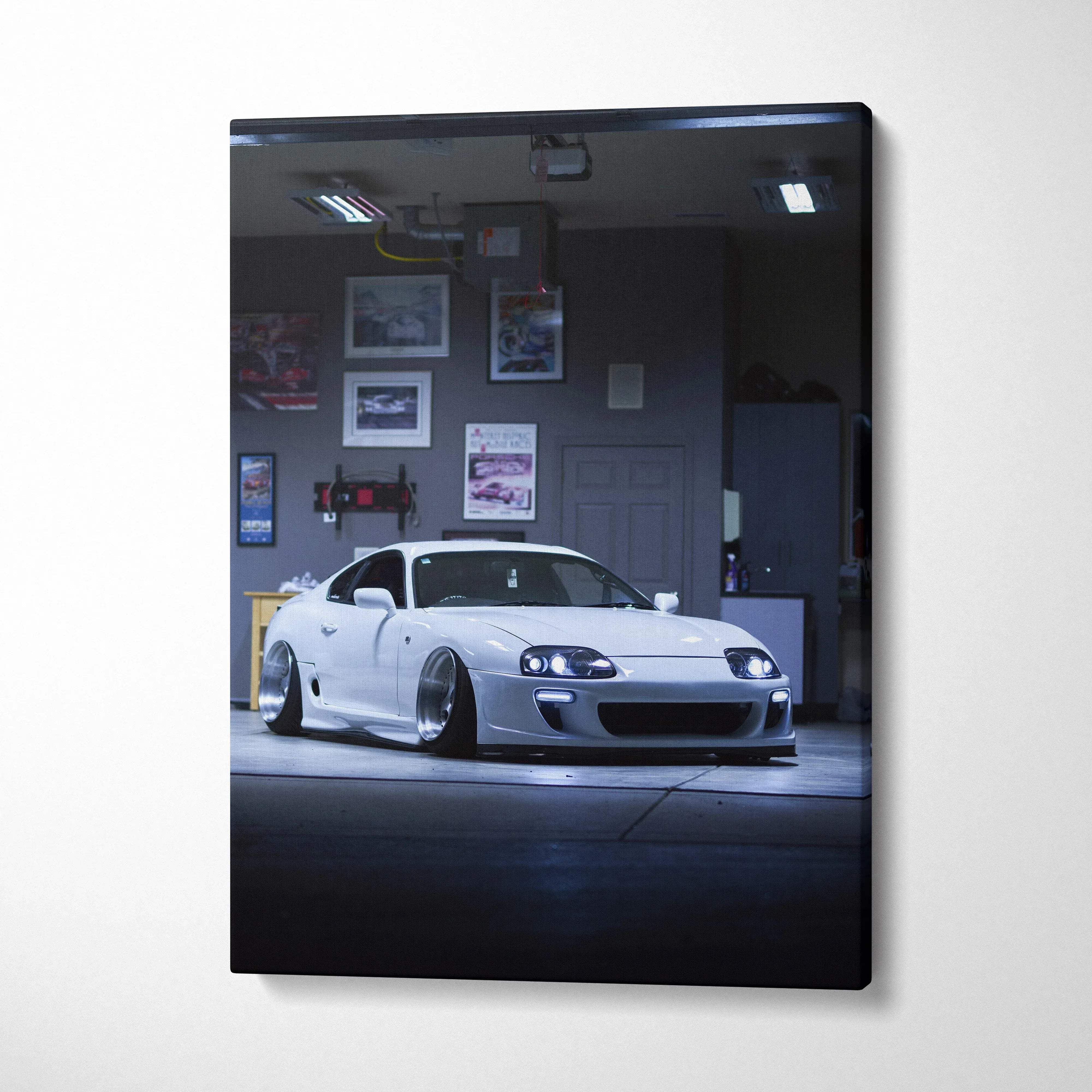 Toyota Supra MK4 white sports car on canvas wall art with dark garage background.